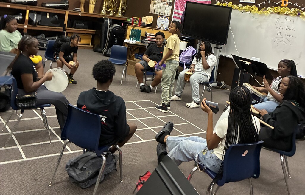 Middle School Student sitting in a circle with drums3