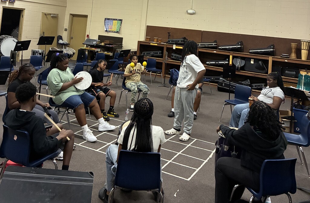 Middle School Student sitting in a circle with drums