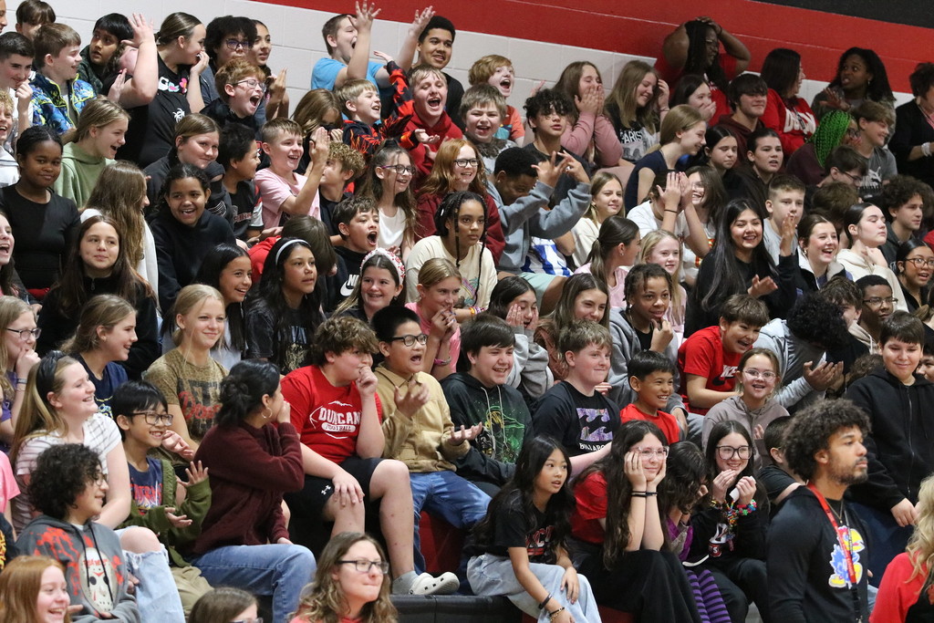 group of students doing the 6-7 motion