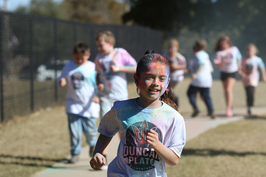 student covered in chalk colors