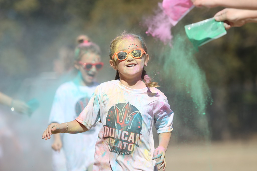 student covered in chalk colors