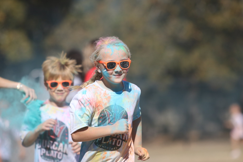 student covered in chalk colors