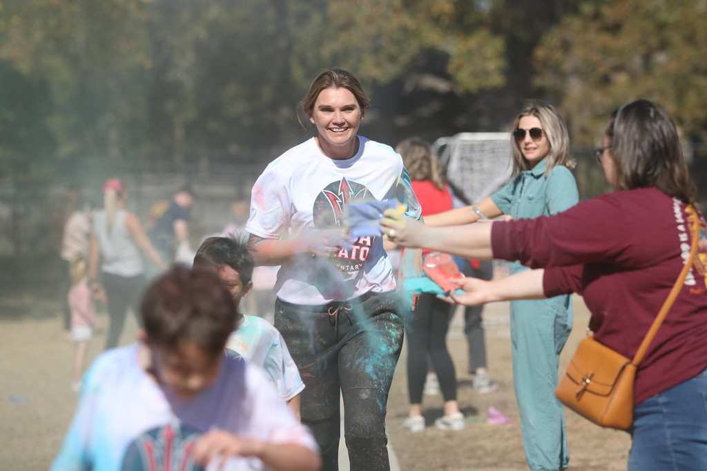 student covered in chalk colors and dr byerly