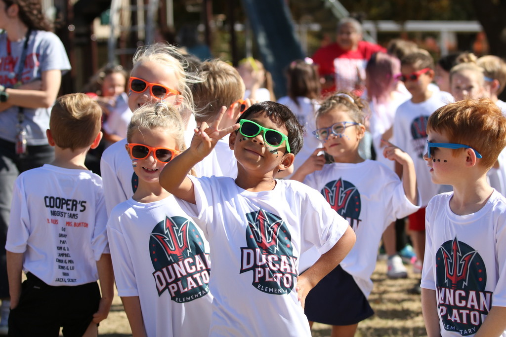 student covered in chalk colors