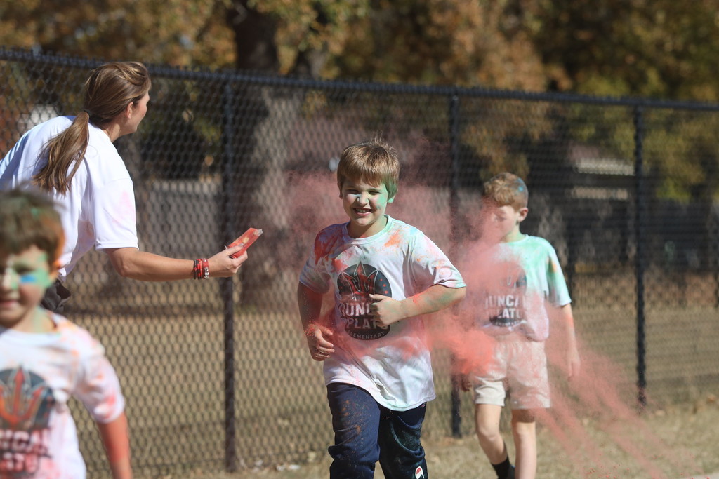 student covered in chalk colors