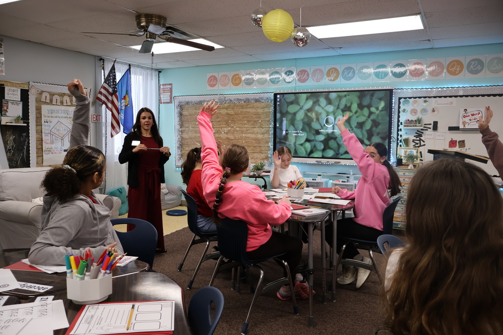 students raising hands to vote on a future project 