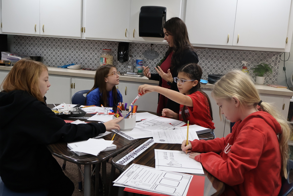 students working on project with teacher 