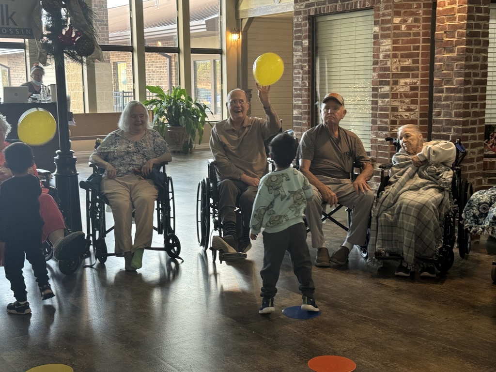 students and grand buddies  playing with balloons 
