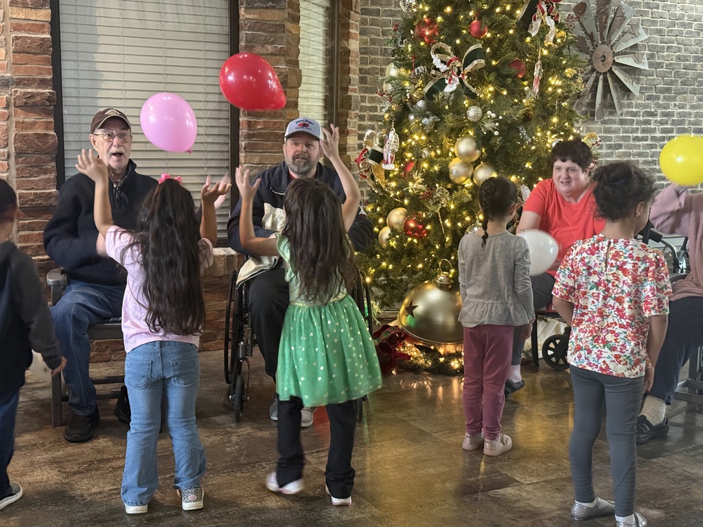 students and grand buddies  playing with balloons 