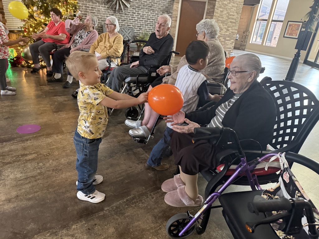 students and grand buddies  playing with balloons 