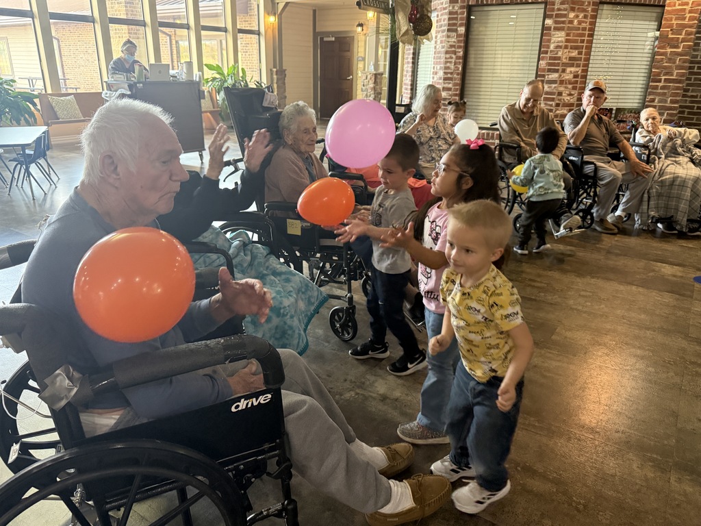 students and grand buddies  playing with balloons 