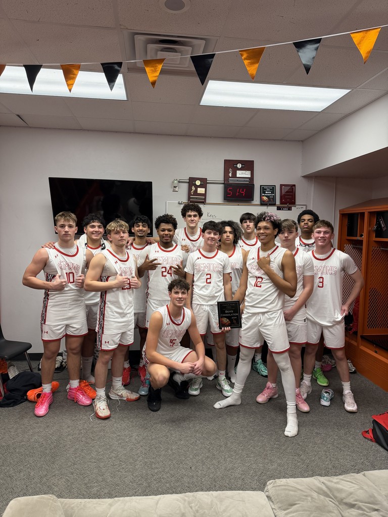 boys basketball team with their trophy for the consolation championship