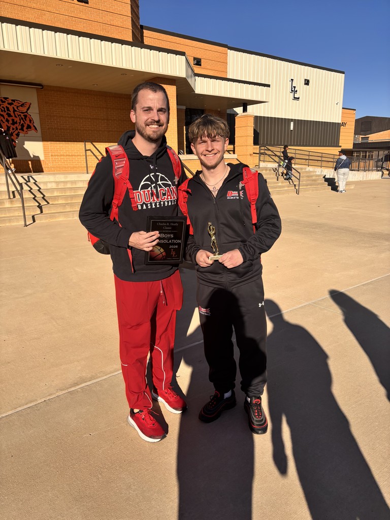 photo of coach and carson carrio for his award being selected for the all tournament team