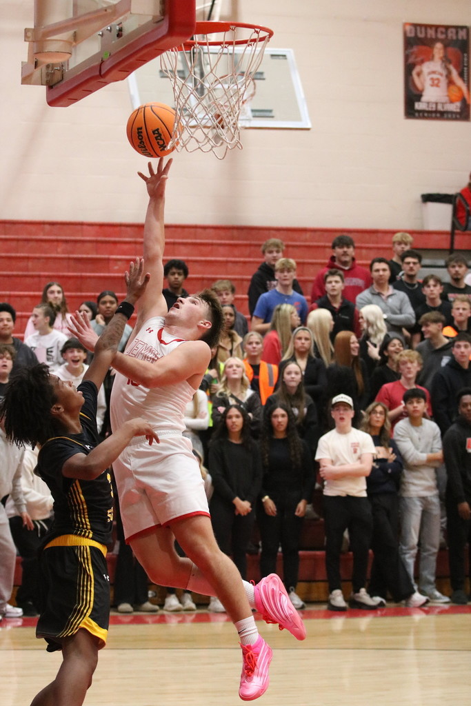 boy shooting basketball