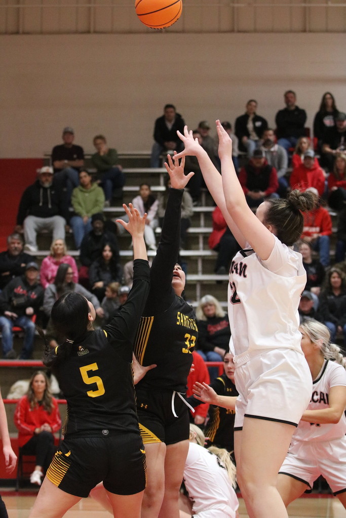girl shooting basketball