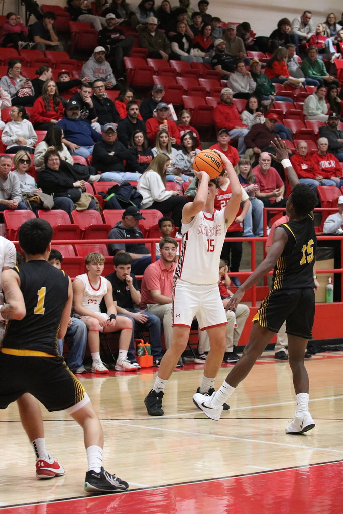 boy shooting basketball