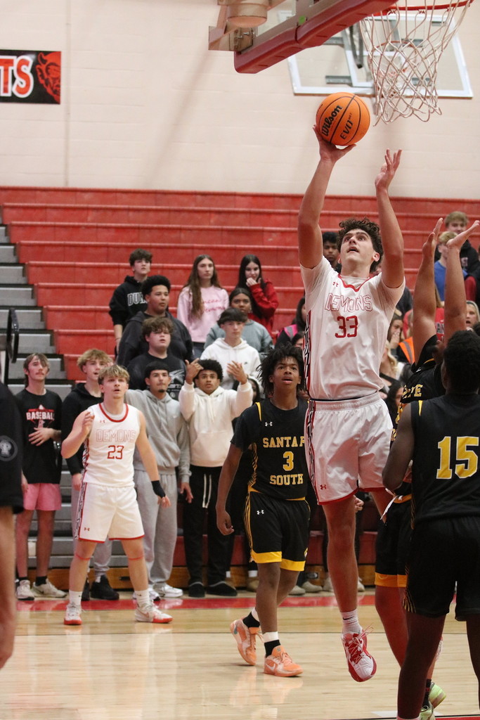 boy shooting basketball