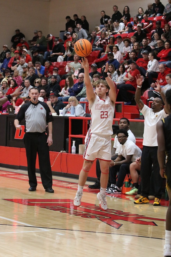 boy shooting basketball