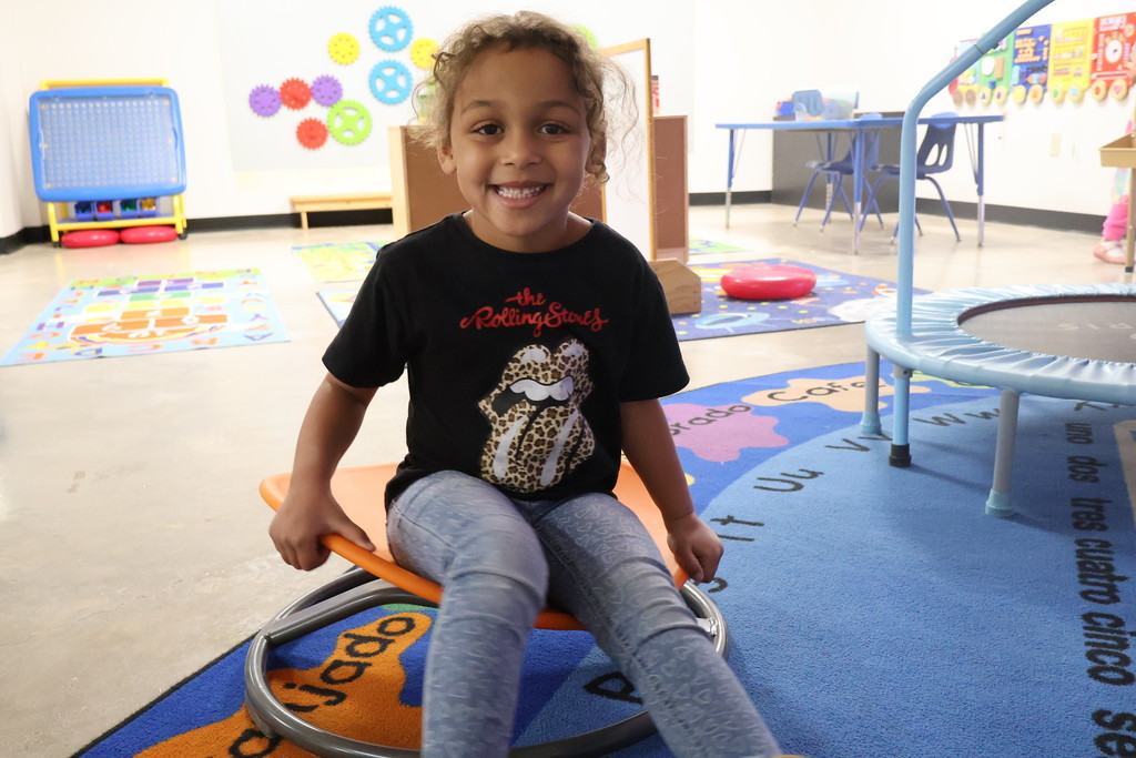 child playing on spinning chair - STEM lab