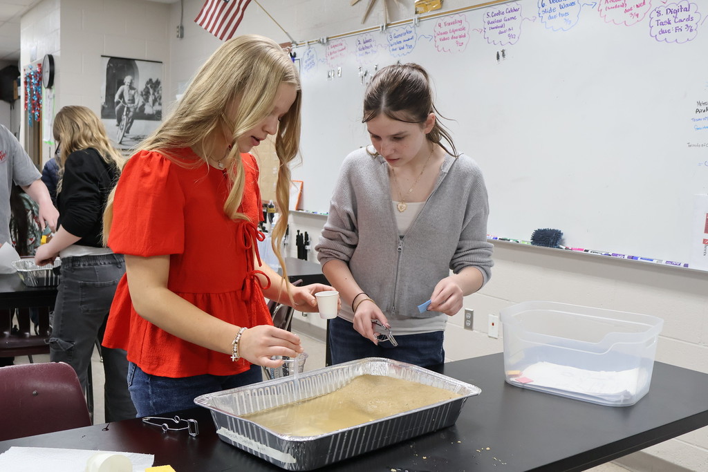 students cleaning up an oil spill after hurricane project