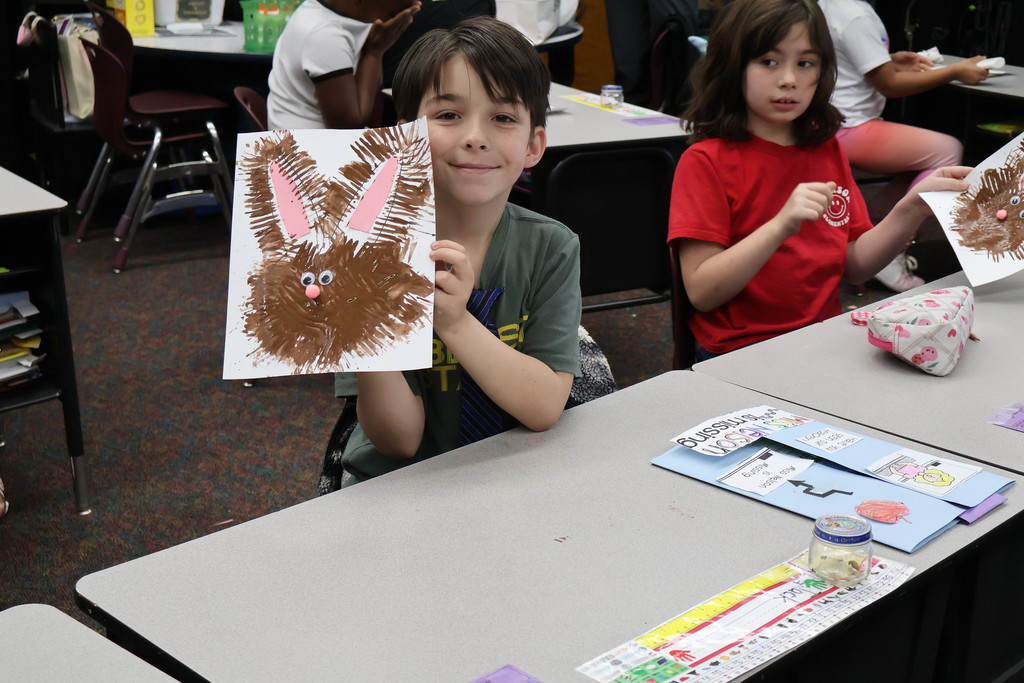 student showing artwork