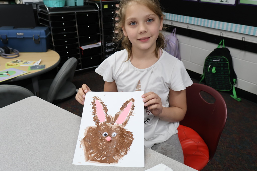 student showing artwork