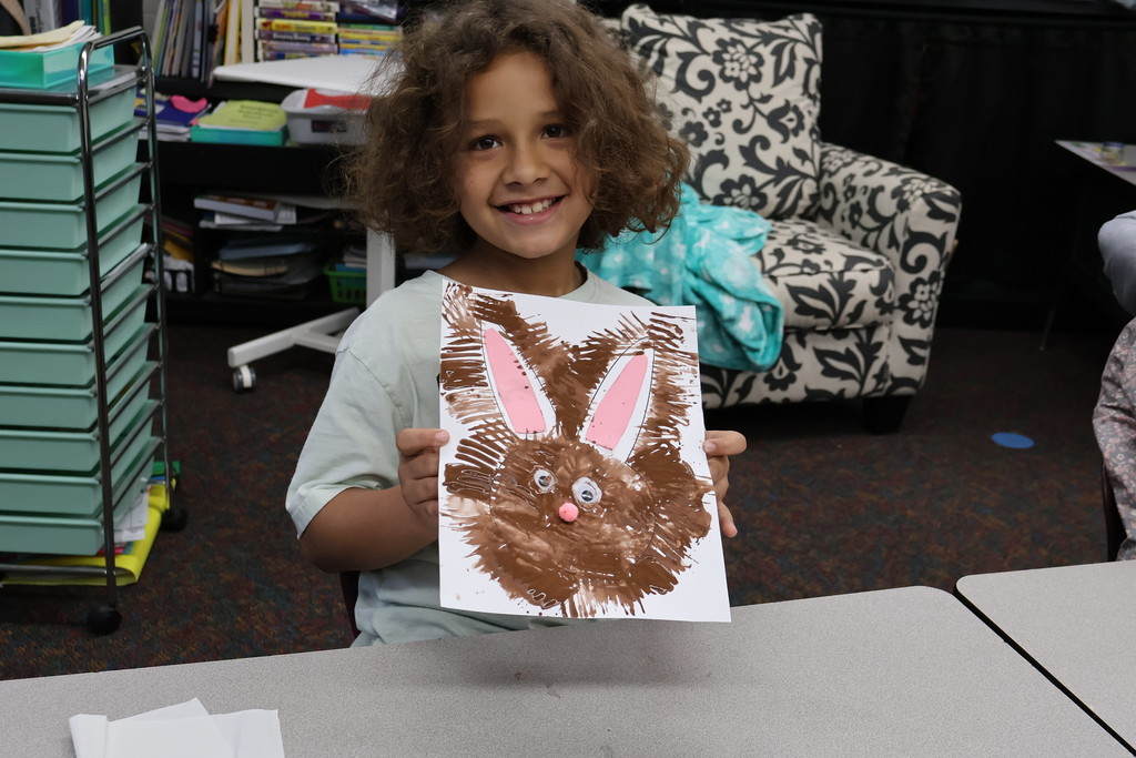 student showing artwork