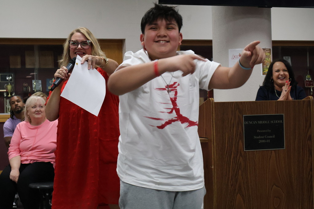 student smiling pointing 