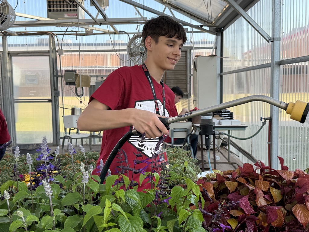 student watering plants 