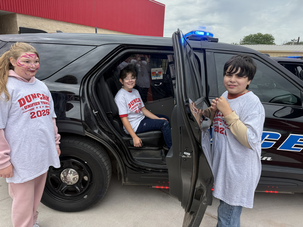 students in police car