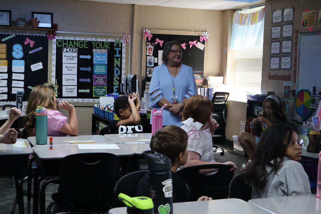 students in class with teacher 