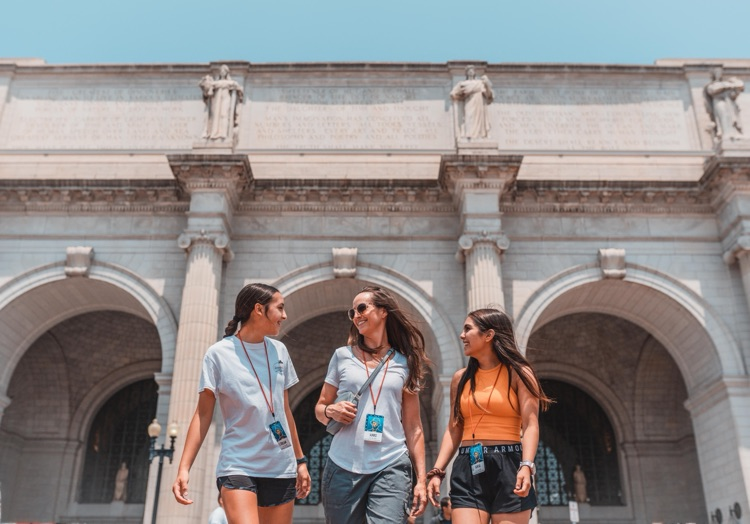mom and two girls wearing lanyard