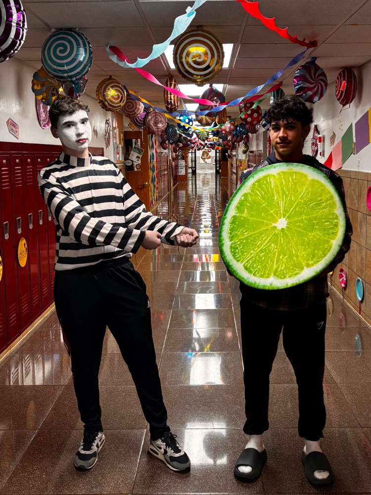 student dressed as mime poses next to student dressed as a lime