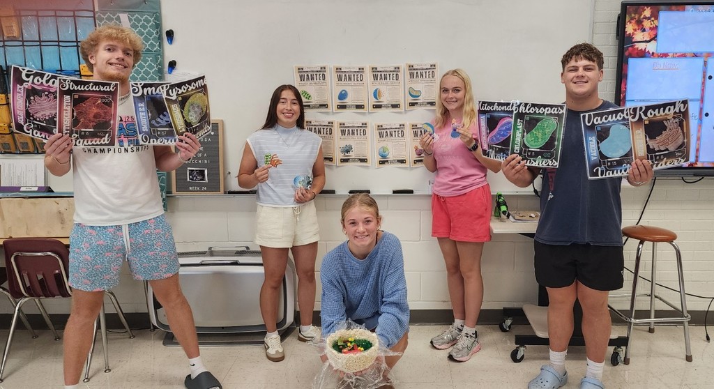 students showing off their organelle projects in biology