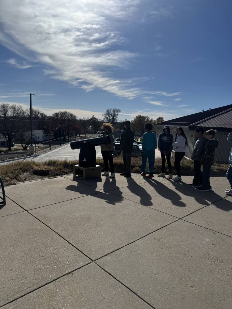 Mr Loghry and the Elementary students looking through his telescopes!