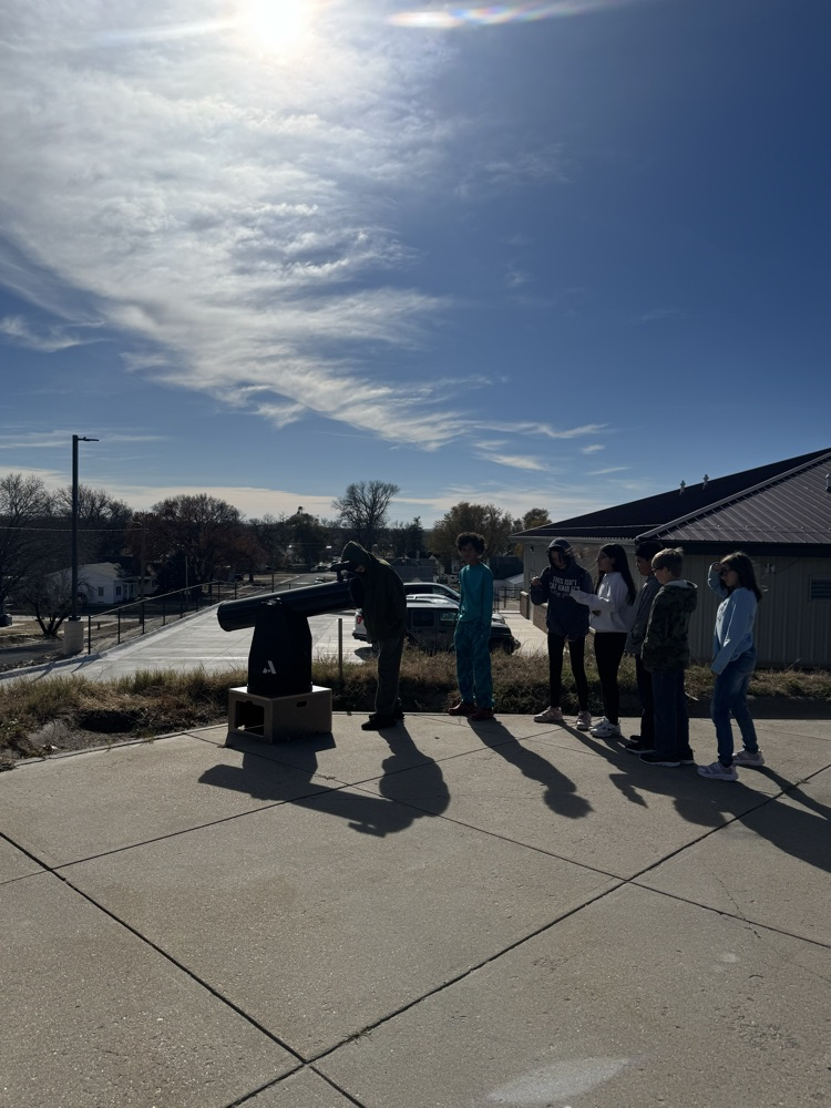 Mr Loghry and the Elementary students looking through his telescopes!