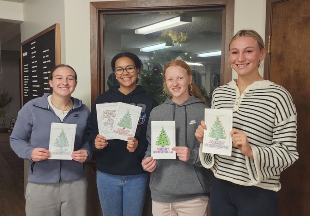 students holding holiday cards