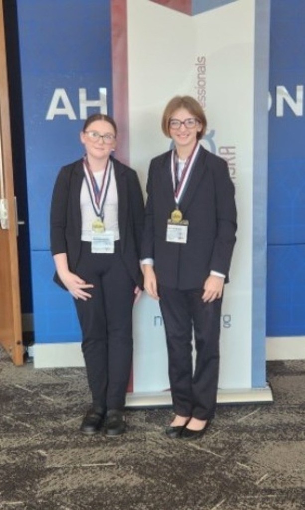Havelynn and Danica holding their awards 