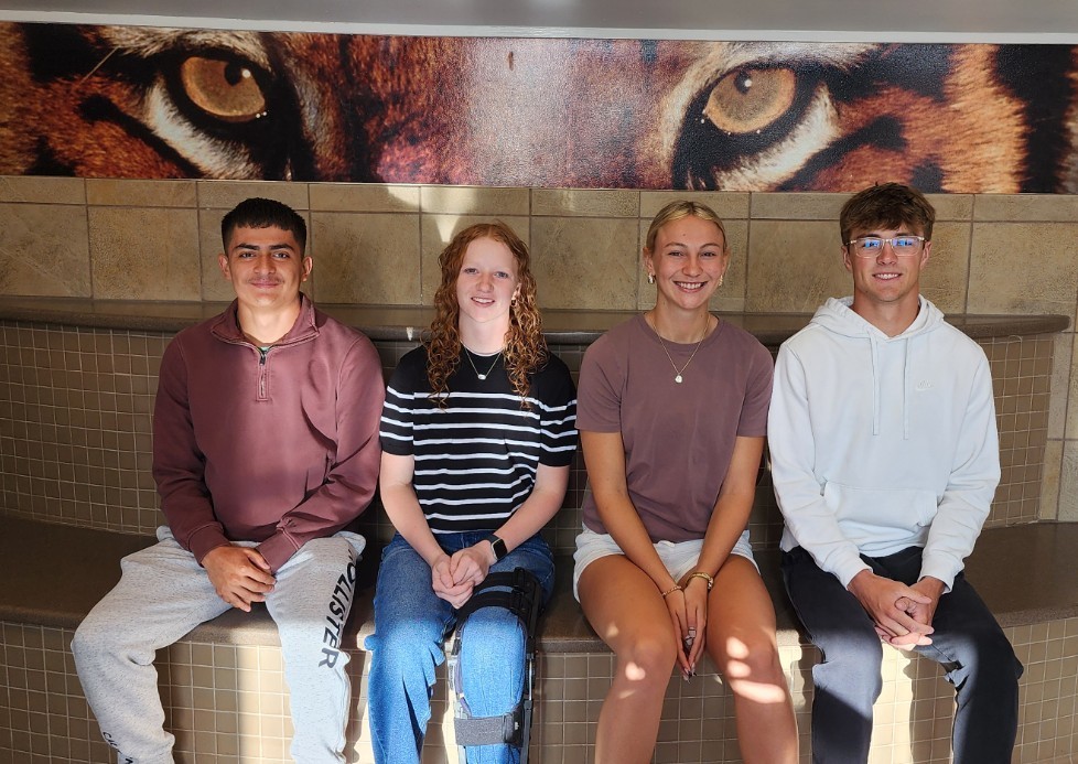 prom candidates sitting in school entry way
