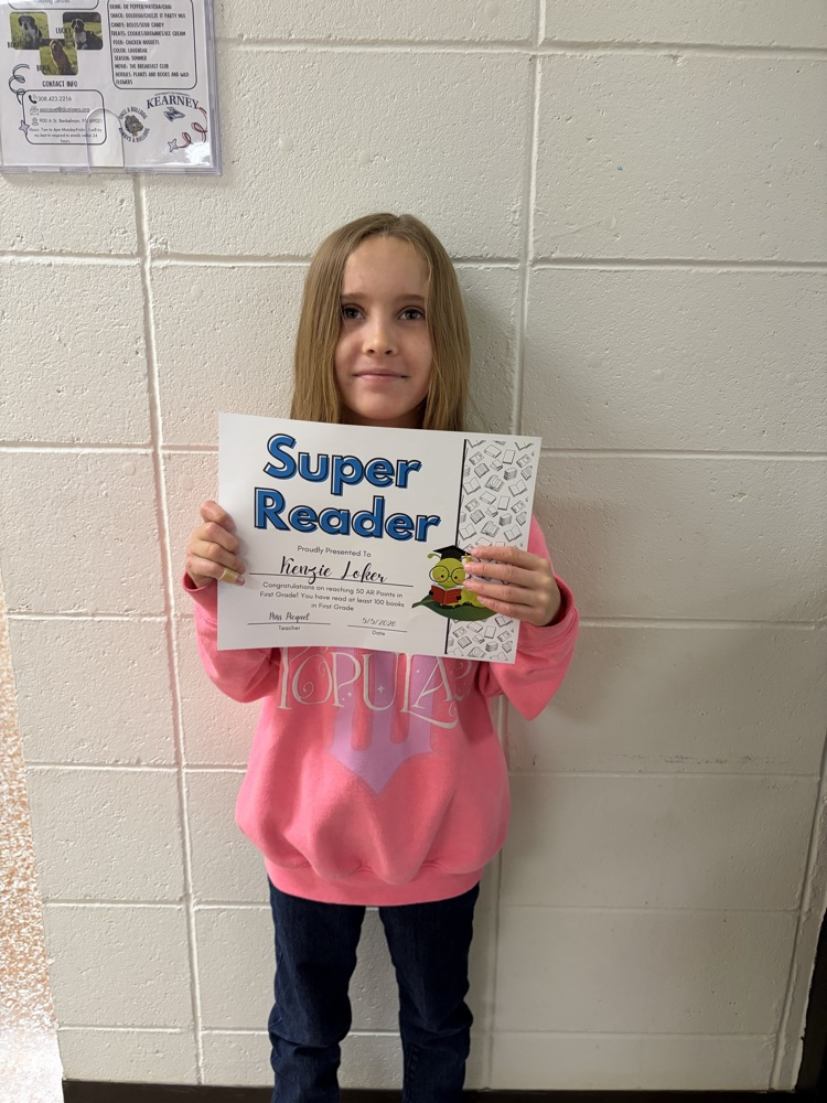 Kenzie holding reading award