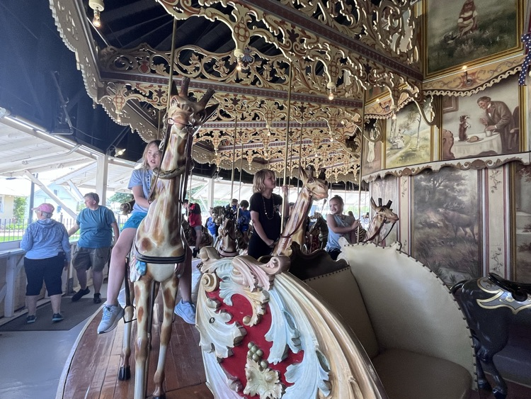 students riding the carousel 