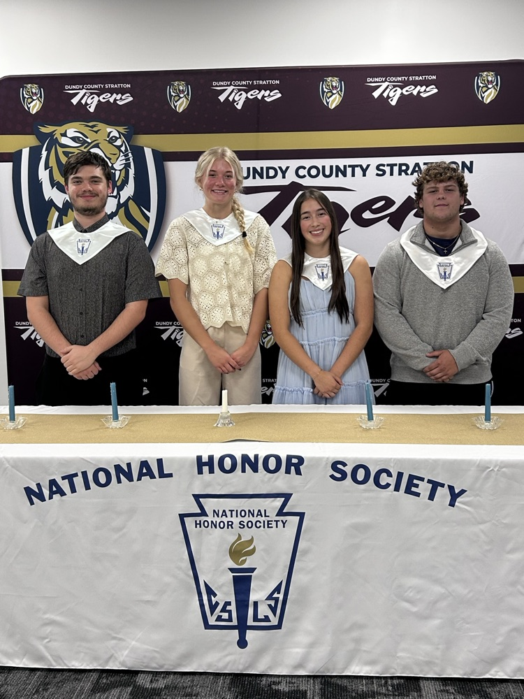 4 senior members pose behind the ceremony table