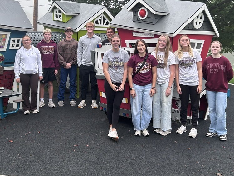 Student Council member stand in front of play houses at the park by the events center in McCook
