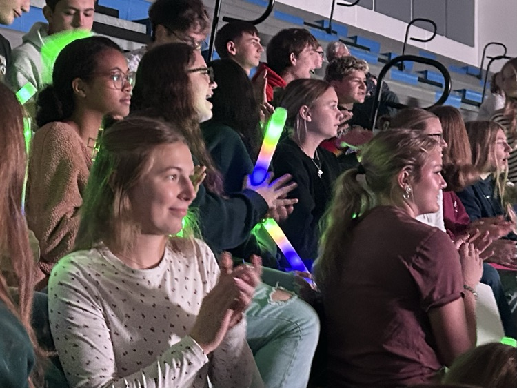 A group of students clapping and singing