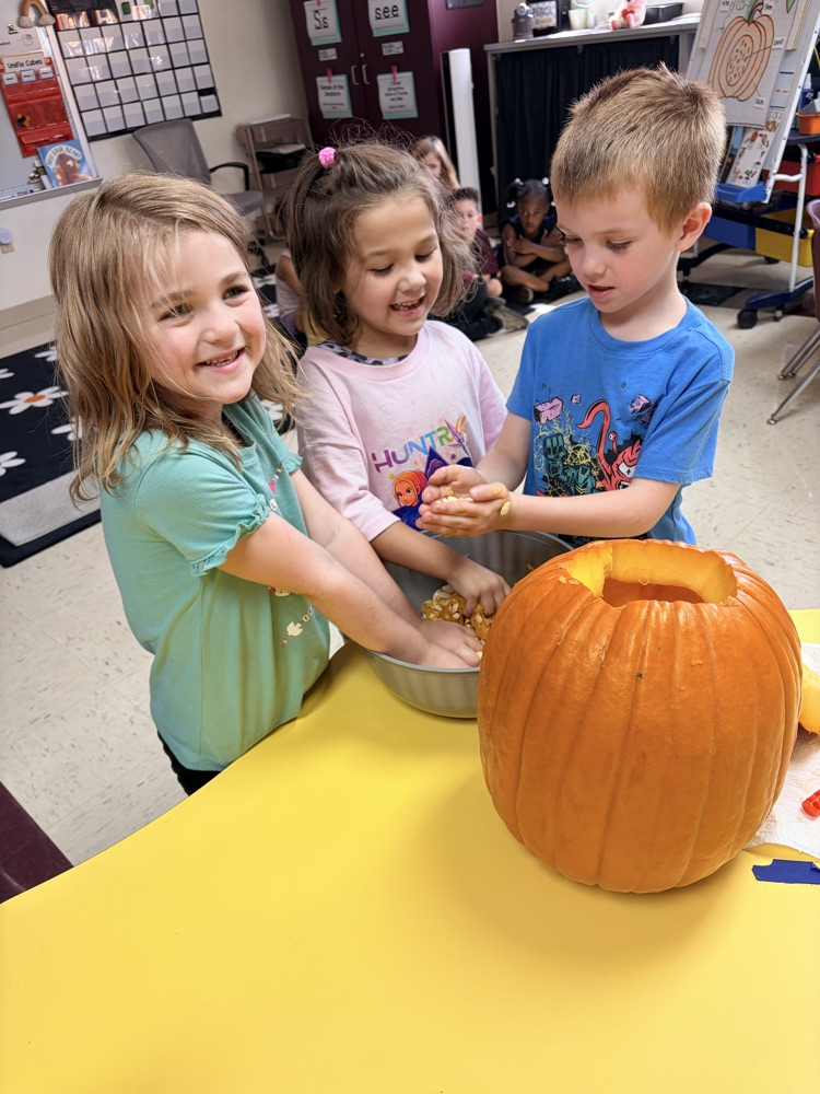children exploring a pumpkin