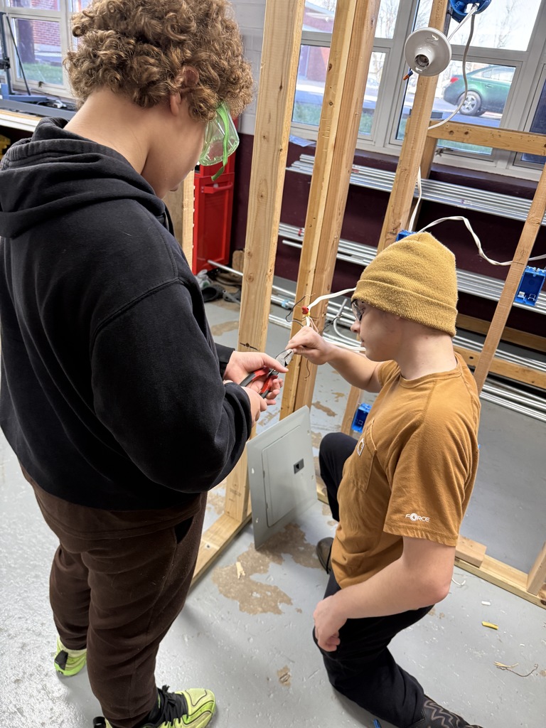 Odin teaching how to twist wires together to create pigtails. 