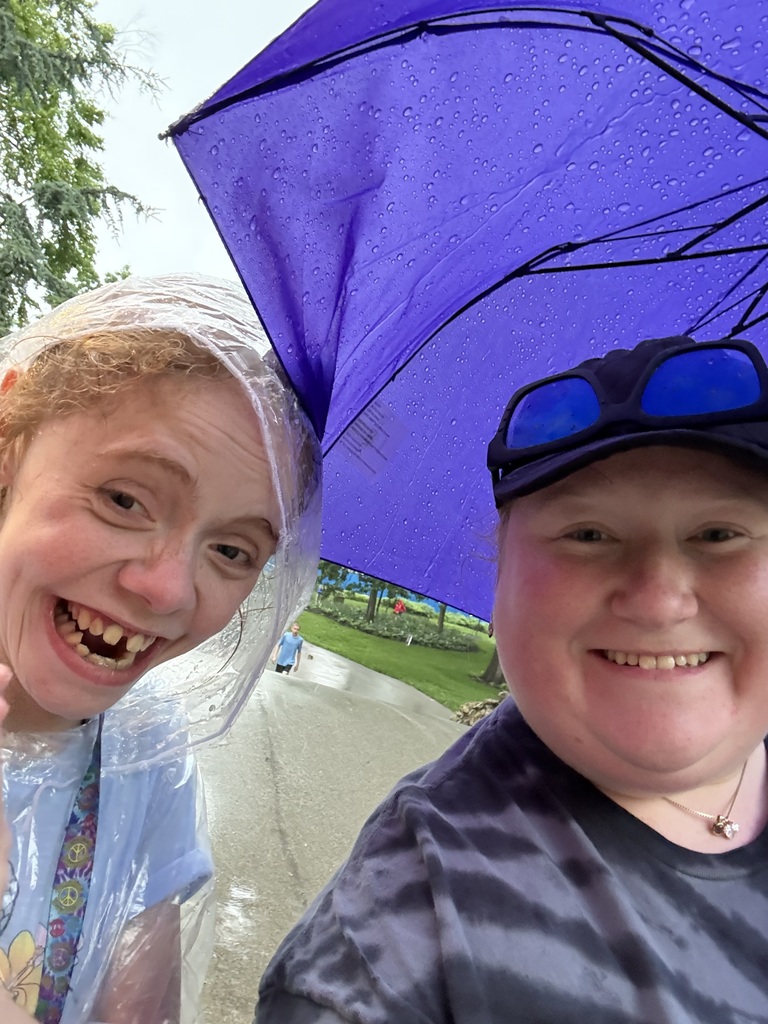 Mrs. Dougherty and Kady walking in the rain
