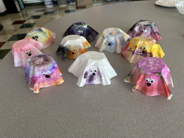 Crafting cute ghosts made from coffee filters, markers, and water.