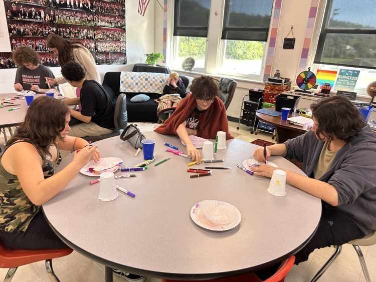 Students in the Tiger Success Center crafting ghosts made from coffee filters