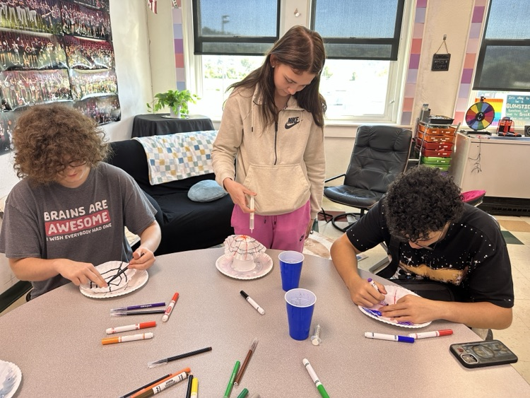 Students in the Tiger Success Center crafting ghosts made from coffee filters.